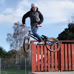 Teenager on a bmx bike midair, performing a stunt