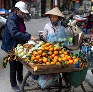 FCE Speaking - Two people buying fruit from a street vendor somewhere in Asia