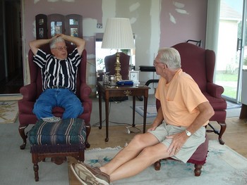 Two older people sitting on chairs
