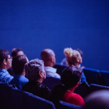A group of people in a cinema theatre, with the screen not pictured